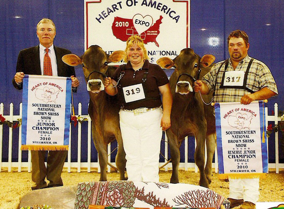 Tammy Voegeli and two champion cows and two men